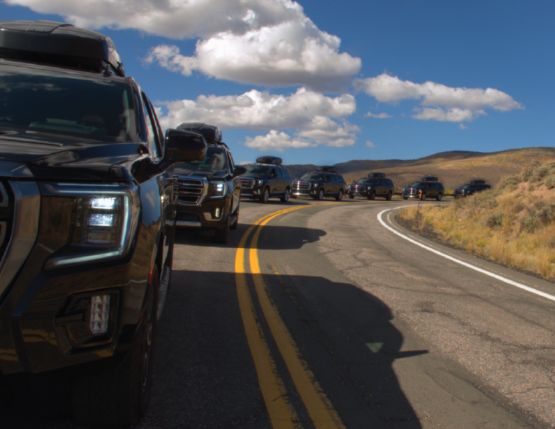 Black Diamond Cars convoy of AWD SUVs on a Colorado mountain road to Vail